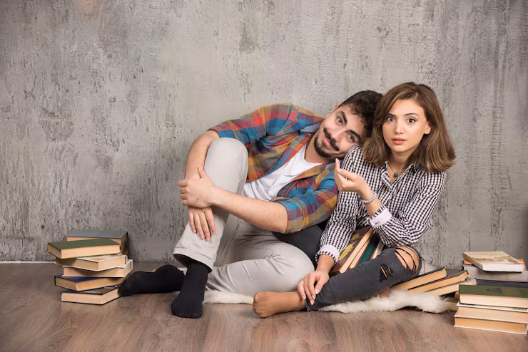 young-couple-sitting-floor-with-books_114579-58534